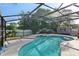 Inviting screened-in pool with lush landscaping and privacy fence creates a tranquil outdoor retreat at 3848 Spirited Cir, St Cloud, FL 34772