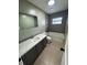 Updated bathroom featuring a gray vanity with a sleek white countertop and a tiled shower-tub combo at 45652 Ohio St, Paisley, FL 32767