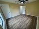 Spacious bedroom with a ceiling fan, two closets, and wood-look floors, offering comfort and ample storage at 45652 Ohio St, Paisley, FL 32767