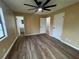 Bedroom featuring stylish laminate flooring, neutral walls, a fan, and access to a bathroom at 45652 Ohio St, Paisley, FL 32767