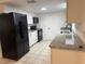 Kitchen featuring stainless steel appliances, white cabinets, granite countertops, and tile floors at 45652 Ohio St, Paisley, FL 32767