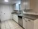 Kitchen featuring stainless steel appliances, white cabinets, granite countertops, and tile floors at 45652 Ohio St, Paisley, FL 32767