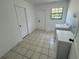 Functional laundry room featuring tile flooring, a window for natural light, and modern washer and dryer at 45652 Ohio St, Paisley, FL 32767