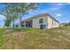 The backyard features a well-maintained lawn and a screened porch at 1803 Daybreak Dr, Fruitland Park, FL 34731