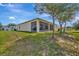 The backyard offers ample space and features a screened porch and lush greenery at 1803 Daybreak Dr, Fruitland Park, FL 34731
