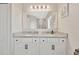 Bathroom featuring dual sinks, granite countertops, and modern vanity with white cabinets at 1803 Daybreak Dr, Fruitland Park, FL 34731