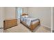 Bedroom with a wooden bed frame and lots of natural light at 1803 Daybreak Dr, Fruitland Park, FL 34731
