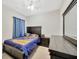 Bedroom with matching wooden furniture set, ceiling fan and star-themed curtains at 1803 Daybreak Dr, Fruitland Park, FL 34731