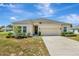 Charming single-story home with a well-maintained lawn and a two-car garage at 1803 Daybreak Dr, Fruitland Park, FL 34731