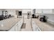 Modern kitchen with stainless steel appliances, white cabinets, and granite countertops at 1803 Daybreak Dr, Fruitland Park, FL 34731