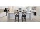 Bright kitchen with white cabinetry, granite countertops, and a breakfast bar with seating at 1803 Daybreak Dr, Fruitland Park, FL 34731