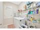 Bright laundry room featuring a washer, dryer, shelving, and storage solutions at 1803 Daybreak Dr, Fruitland Park, FL 34731