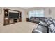 Cozy living room featuring a large television, comfortable seating, and ample natural light at 1803 Daybreak Dr, Fruitland Park, FL 34731