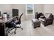 Home office featuring a desk, chair, ottoman, and window with natural light at 1803 Daybreak Dr, Fruitland Park, FL 34731