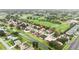 Overhead shot of a house with a red tile roof nestled near a golf course in a suburban setting at 2524 Albion Ave, Orlando, FL 32833