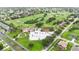 Wide aerial shot featuring a golf course and clubhouse near a residential area with tree coverage at 2524 Albion Ave, Orlando, FL 32833