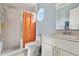 Bright bathroom with a walk-in shower, modern vanity, and a unique circular window at 2524 Albion Ave, Orlando, FL 32833