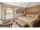 Serene bedroom with a wicker bed frame, decorative pillows, and a cozy sitting area by the window at 2524 Albion Ave, Orlando, FL 32833