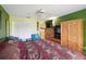 A bedroom with a large closet, ceiling fan, and an elaborate wooden entertainment center at 2524 Albion Ave, Orlando, FL 32833