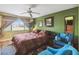 This bedroom features a ceiling fan, an outdoor view, and a relaxing chair at 2524 Albion Ave, Orlando, FL 32833