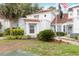 Home featuring green landscaping, a red tile roof, white stucco, and a black flag at 2524 Albion Ave, Orlando, FL 32833