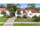 Charming two-story home with a red tile roof, lush landscaping, and inviting curb appeal at 2524 Albion Ave, Orlando, FL 32833