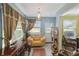 Bright sunroom featuring a charming yellow couch, tile flooring, and natural light from large windows at 2524 Albion Ave, Orlando, FL 32833