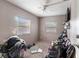 Bedroom with two windows, ceiling fan and wall-mounted television at 1224 S Delaware Ave, Deland, FL 32720