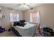 Carpeted bedroom featuring a bed, ceiling fan and window with curtains at 1224 S Delaware Ave, Deland, FL 32720