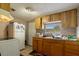 This kitchen features wood cabinets, linoleum counters, and a white refrigerator at 1224 S Delaware Ave, Deland, FL 32720