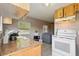 Cozy kitchen featuring tile floors, standard appliances and laminate countertops at 1224 S Delaware Ave, Deland, FL 32720