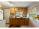 This kitchen has wood cabinets, linoleum counters and tile floors at 1224 S Delaware Ave, Deland, FL 32720