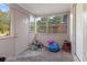 Bright sunroom with multiple windows and a door leading outside at 1224 S Delaware Ave, Deland, FL 32720