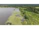 Aerial perspective reveals the land's picturesque lakefront, merging with lush, abundant vegetation at 1611 County Road 753S, Webster, FL 33597