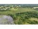 Aerial image featuring a tranquil pond and lush surroundings, highlighting the property's natural beauty and peaceful setting at 1611 County Road 753S, Webster, FL 33597