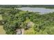 Aerial view displays this home in a wooded area near the lake, complete with a detached garage at 1611 County Road 753S, Webster, FL 33597