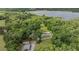 Aerial view showcasing the lakefront home nestled among lush greenery and serene surroundings at 1611 County Road 753S, Webster, FL 33597