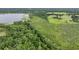 Expansive aerial view of the property, showcasing lush greenery, a serene lake, and natural beauty at 1611 County Road 753S, Webster, FL 33597