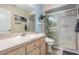 Bathroom with a light blue accent wall, modern toilet and vanity, and glass enclosed shower at 1611 County Road 753S, Webster, FL 33597