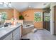 Bright bathroom featuring double sink vanity, soaking tub, and separate glass enclosed shower at 1611 County Road 753S, Webster, FL 33597