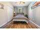 Cozy bedroom with wood floors, a comfortable bed, and ample closet space for storage at 1611 County Road 753S, Webster, FL 33597