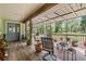 Spacious covered porch with wood flooring and rustic furniture for relaxing and enjoying the outdoors at 1611 County Road 753S, Webster, FL 33597