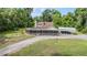 Aerial view showcases a home with a large screened porch and ample parking on gravel circular driveway at 1611 County Road 753S, Webster, FL 33597