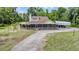 Aerial view featuring a home with a screened porch and attached lean-to, surrounded by open lawns at 1611 County Road 753S, Webster, FL 33597
