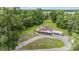 Aerial view of a home with a screened in back porch and car port on an ample lawn area at 1611 County Road 753S, Webster, FL 33597