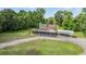 Aerial view showcasing the home with a screened porch, car port, and landscaped surroundings at 1611 County Road 753S, Webster, FL 33597