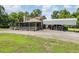 Exterior view of the home with screened porch and convenient adjacent covered parking for vehicles at 1611 County Road 753S, Webster, FL 33597