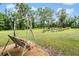 Inviting swing overlooking a serene pond, surrounded by lush greenery and mature trees at 1611 County Road 753S, Webster, FL 33597