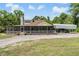 Exterior view of a home featuring a screened porch and a covered parking area at 1611 County Road 753S, Webster, FL 33597