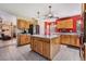 Well lit kitchen with light wood cabinets, tiled floors, and an island with plenty of storage at 1611 County Road 753S, Webster, FL 33597